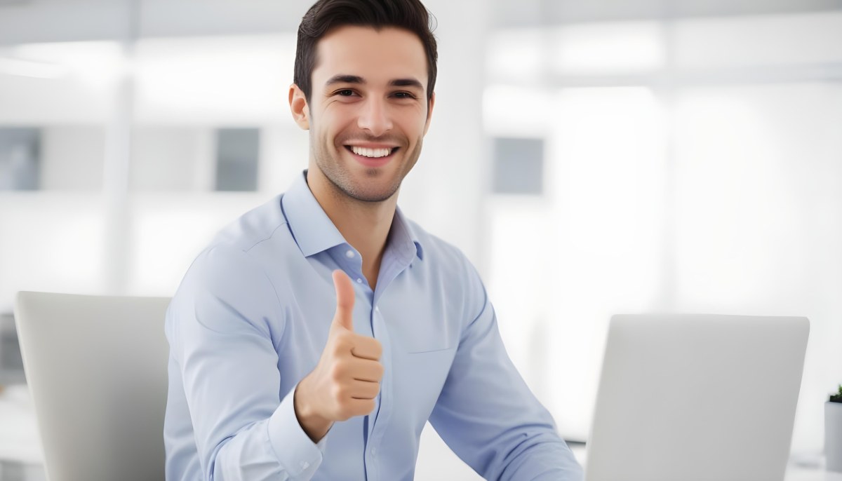 A Caucasian Man 28 Years Old Dark Hair Smiling And Doing A Thumbs Up In A Bright Office 16 8714