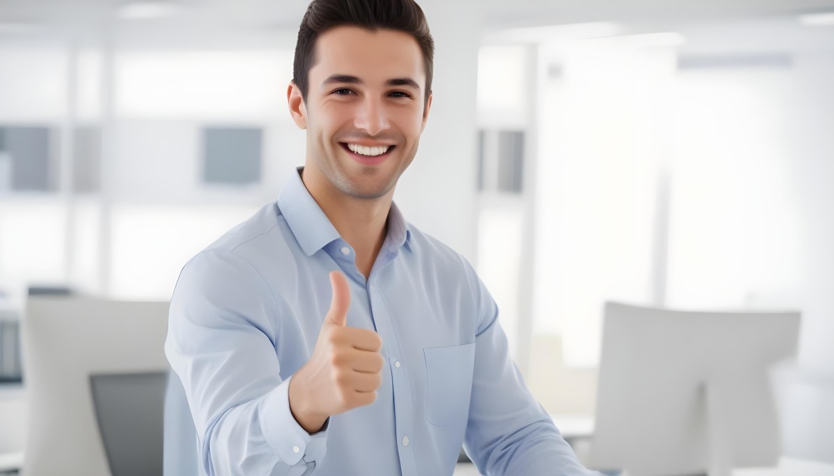 A Caucasian Man 28 Years Old Dark Hair Smiling And Doing A Thumbs Up In A Bright Office 18 E8c6