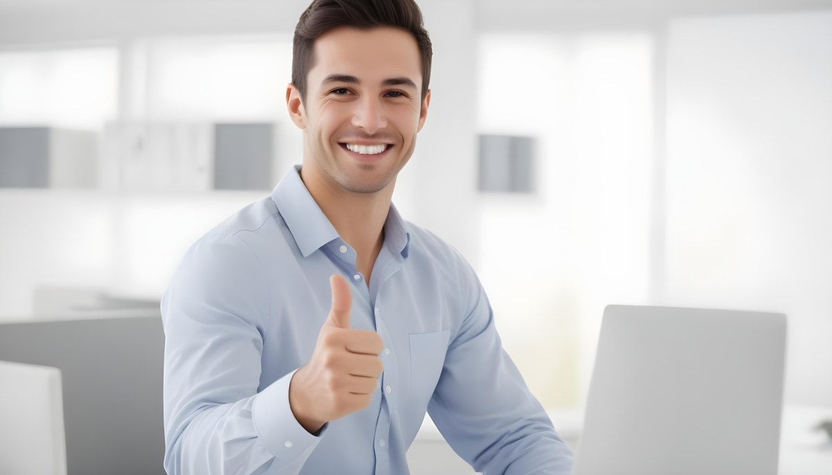 A Caucasian Man 28 Years Old Dark Hair Smiling And Doing A Thumbs Up In A Bright Office 22 451c