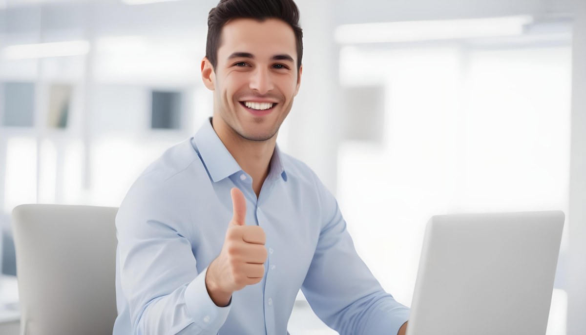 A Caucasian Man 28 Years Old Dark Hair Smiling And Doing A Thumbs Up In A Bright Office 26 5db6