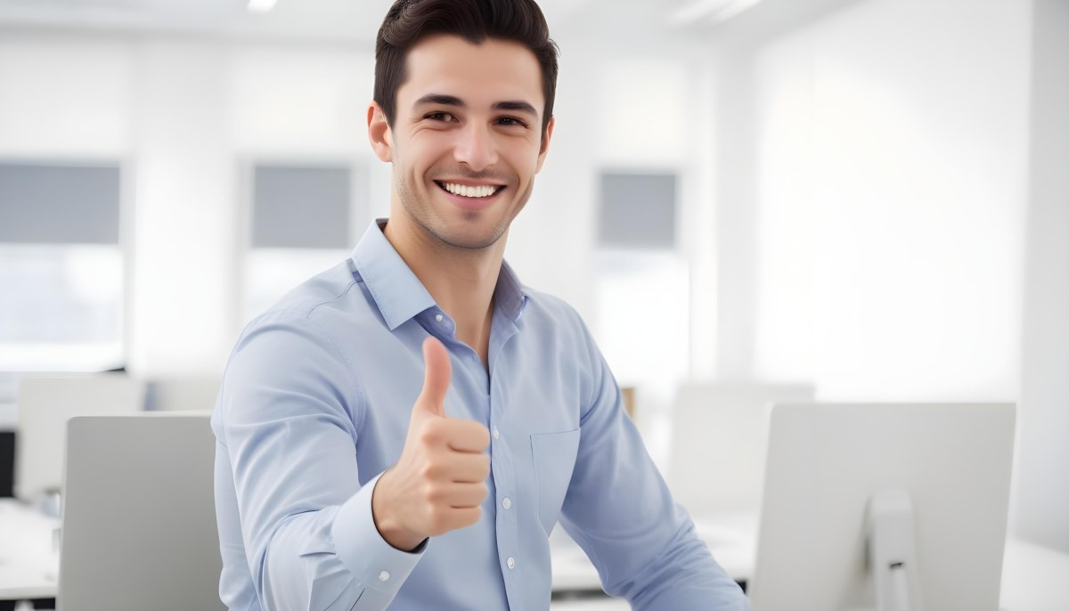 A Caucasian Man 28 Years Old Dark Hair Smiling And Doing A Thumbs Up In A Bright Office 28 59bb