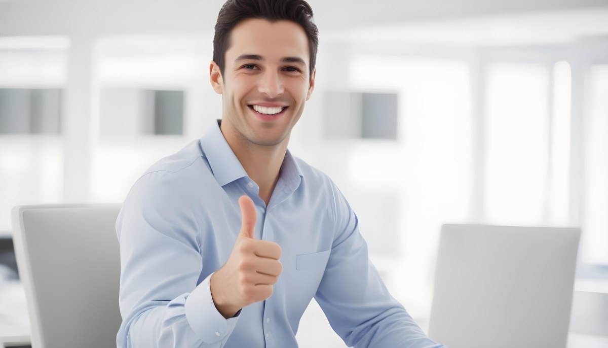 A Caucasian Man 28 Years Old Dark Hair Smiling And Doing A Thumbs Up In A Bright Office 32 327d
