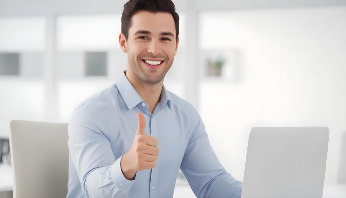A Caucasian Man 28 Years Old Dark Hair Smiling And Doing A Thumbs Up In A Bright Office 9 5f18