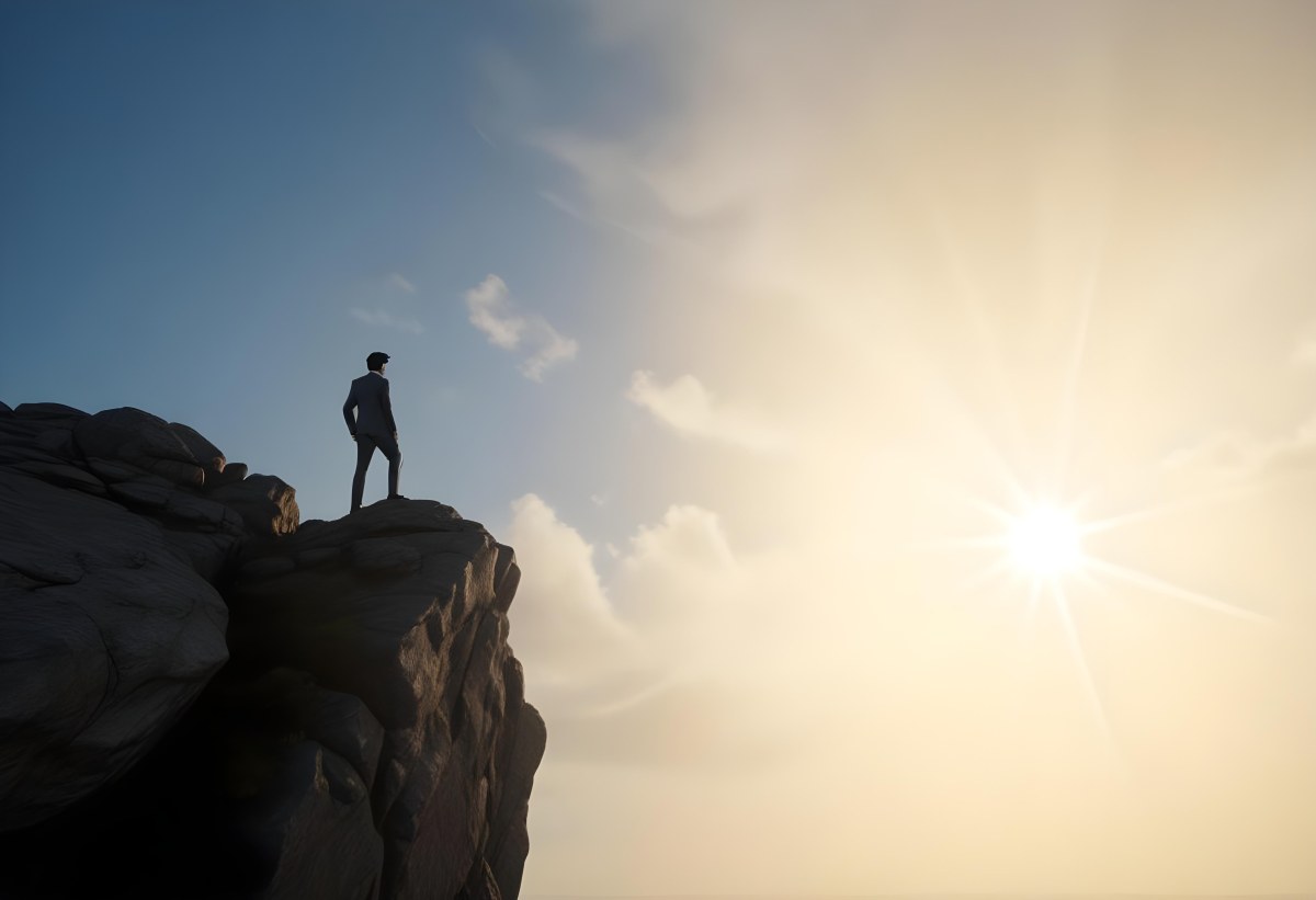 A Caucasian Man 30 Years Old With Black Hair Wearing A Suit Standing On A Cliff With A Cloudy Sky And The Sun In The Background 1 D87a