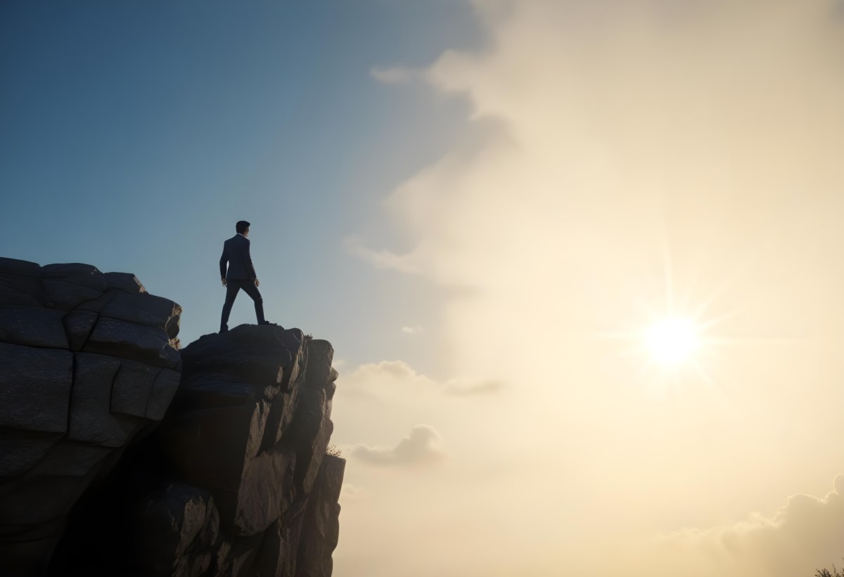 A Caucasian Man 30 Years Old With Black Hair Wearing A Suit Standing On A Cliff With A Cloudy Sky And The Sun In The Background 5 D423