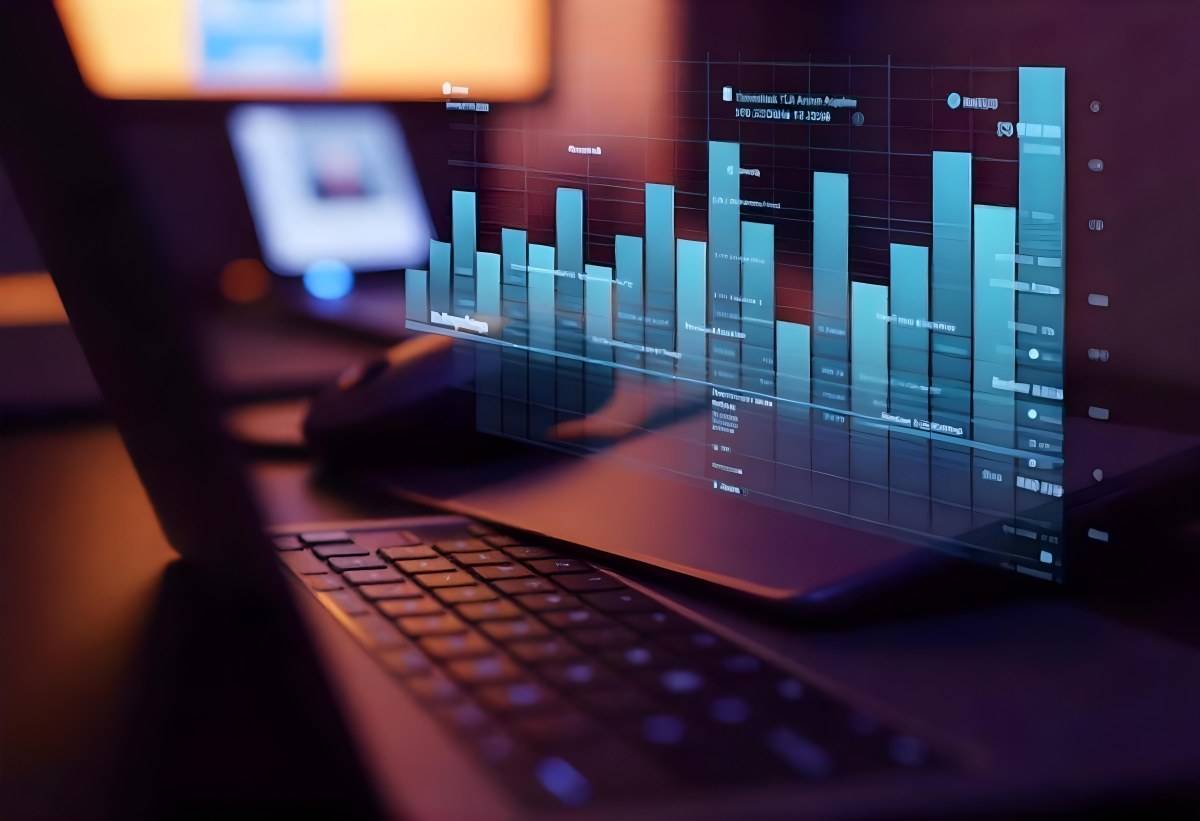 A Laptop With A Keyboard And A Screen Displaying Financial Data With A Bar Graph Overlayed On Top In An Office Environment 4 7d13