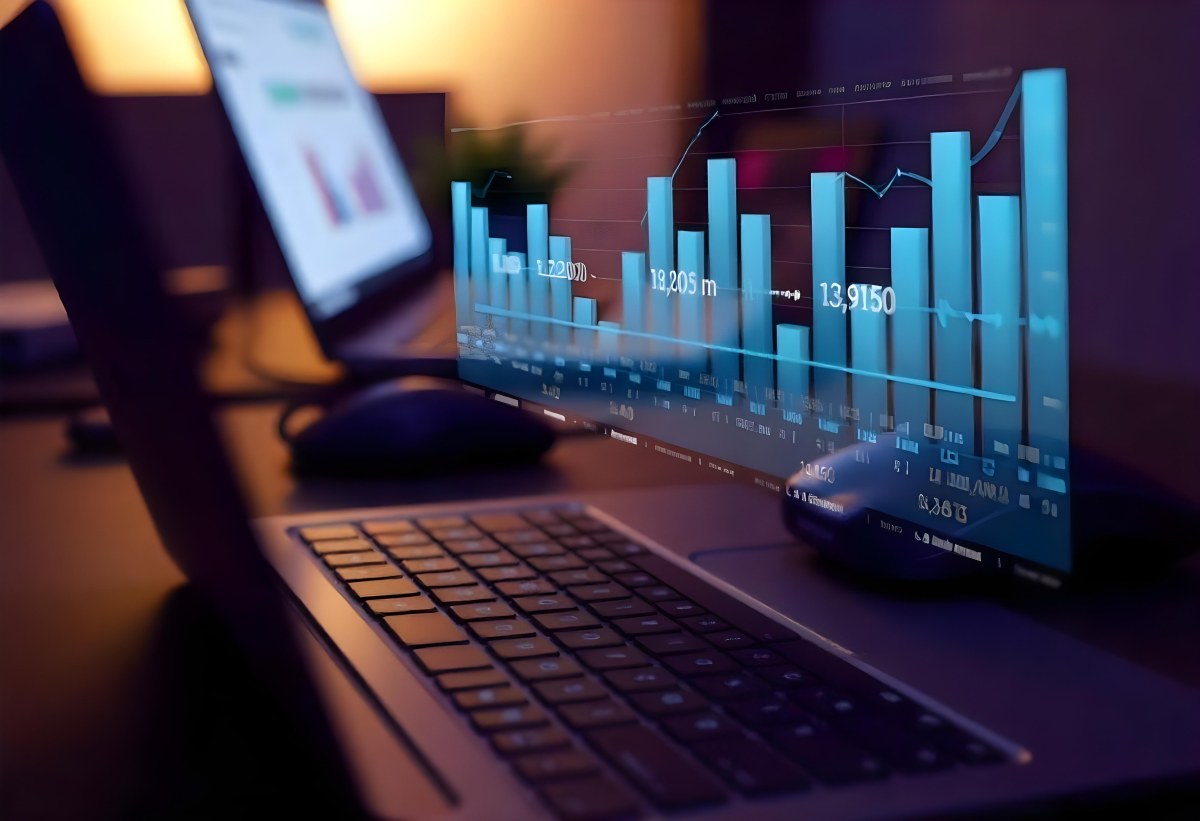 A Laptop With A Keyboard And A Screen Displaying Financial Data With A Bar Graph Overlayed On Top In An Office Environment 6 0d9c