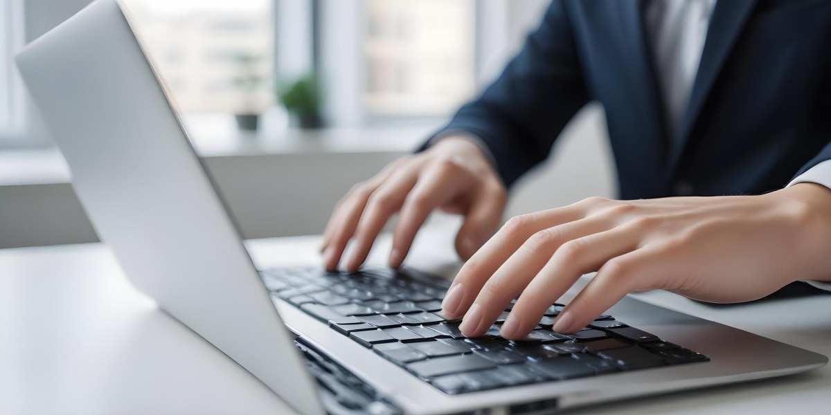 A Person S Hands Typing On A Laptop Keyboard In A Blurred Office Environment 6 Db60