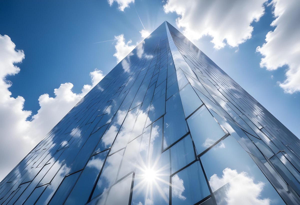 Low Angle Shot Of A Modern Glass Skyscraper Reflecting The Blue Sky And White Clouds Sun Shining Through The Clouds Creating A Bright And Airy Atmosphere 23 Ce88
