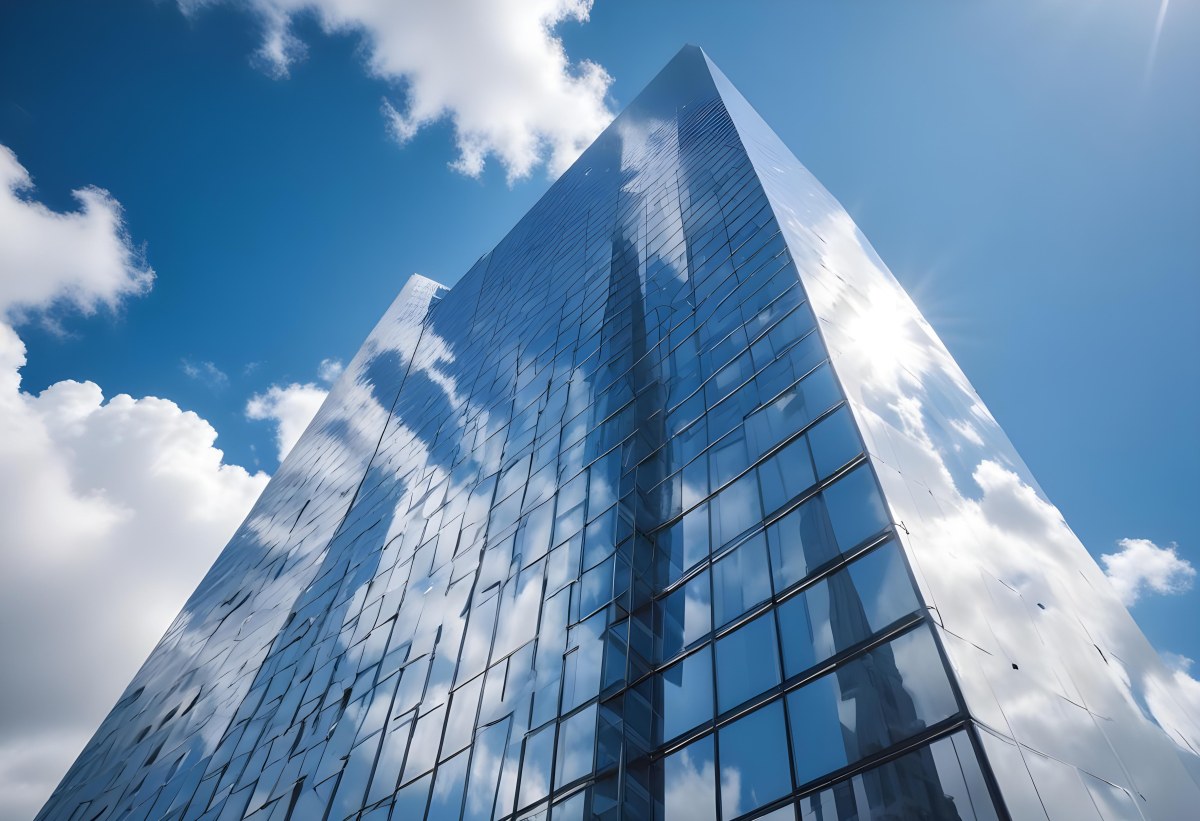 Low Angle Shot Of A Modern Glass Skyscraper Reflecting The Blue Sky And White Clouds Sun Shining Through The Clouds Creating A Bright And Airy Atmosphere 52 Caf0