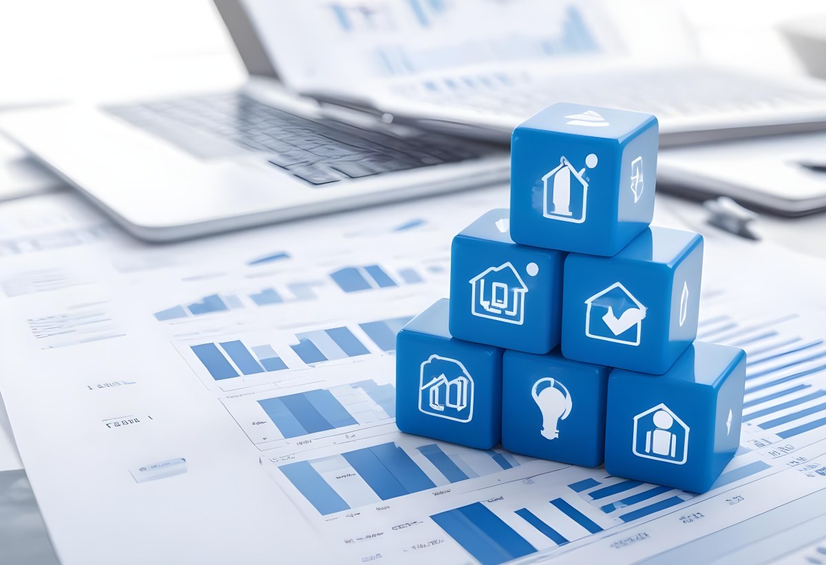 Stack Of Blue Cubes With Business Icons On Top Of A Financial Report With A Laptop In The Background 19 De32