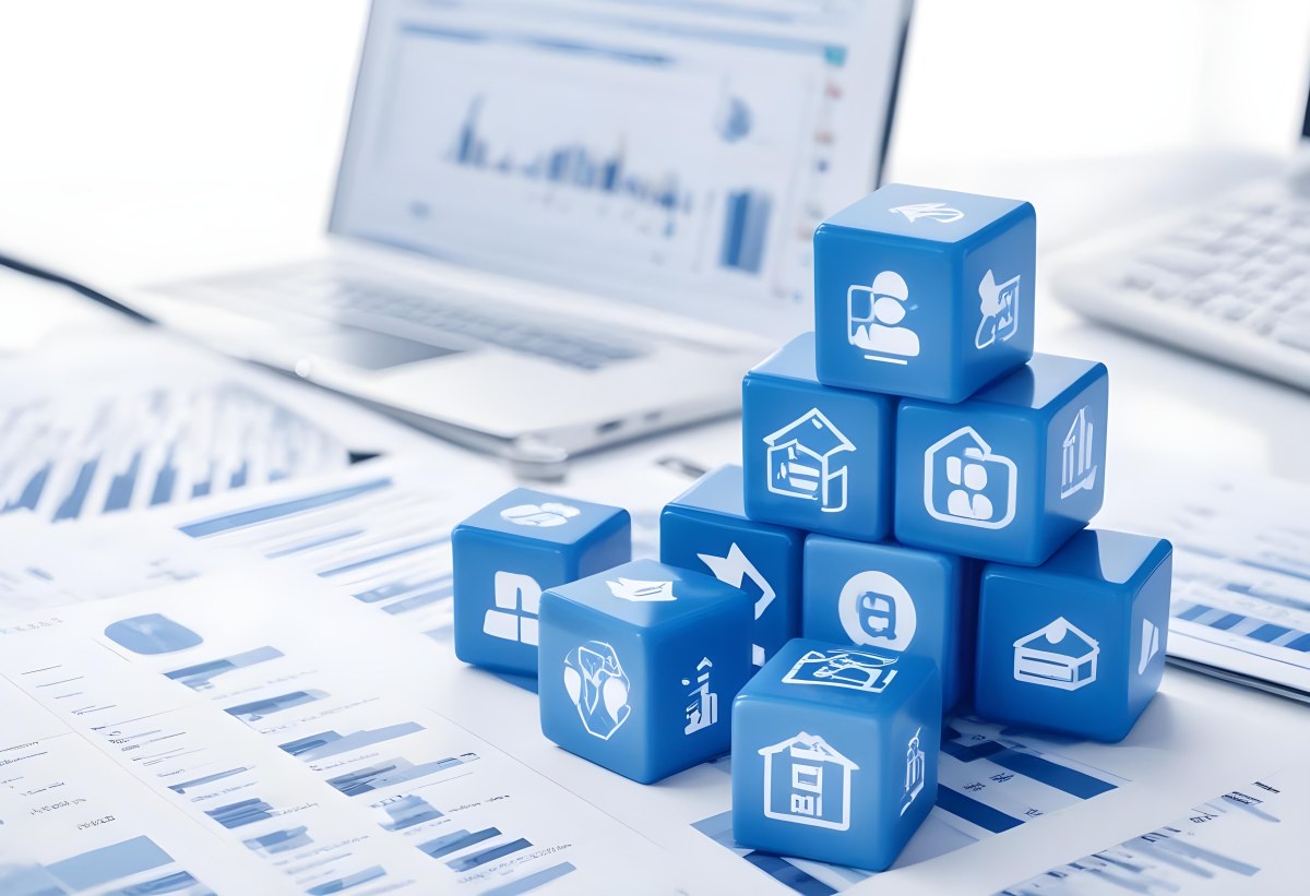 Stack Of Blue Cubes With Business Icons On Top Of A Financial Report With A Laptop In The Background 28 4a12