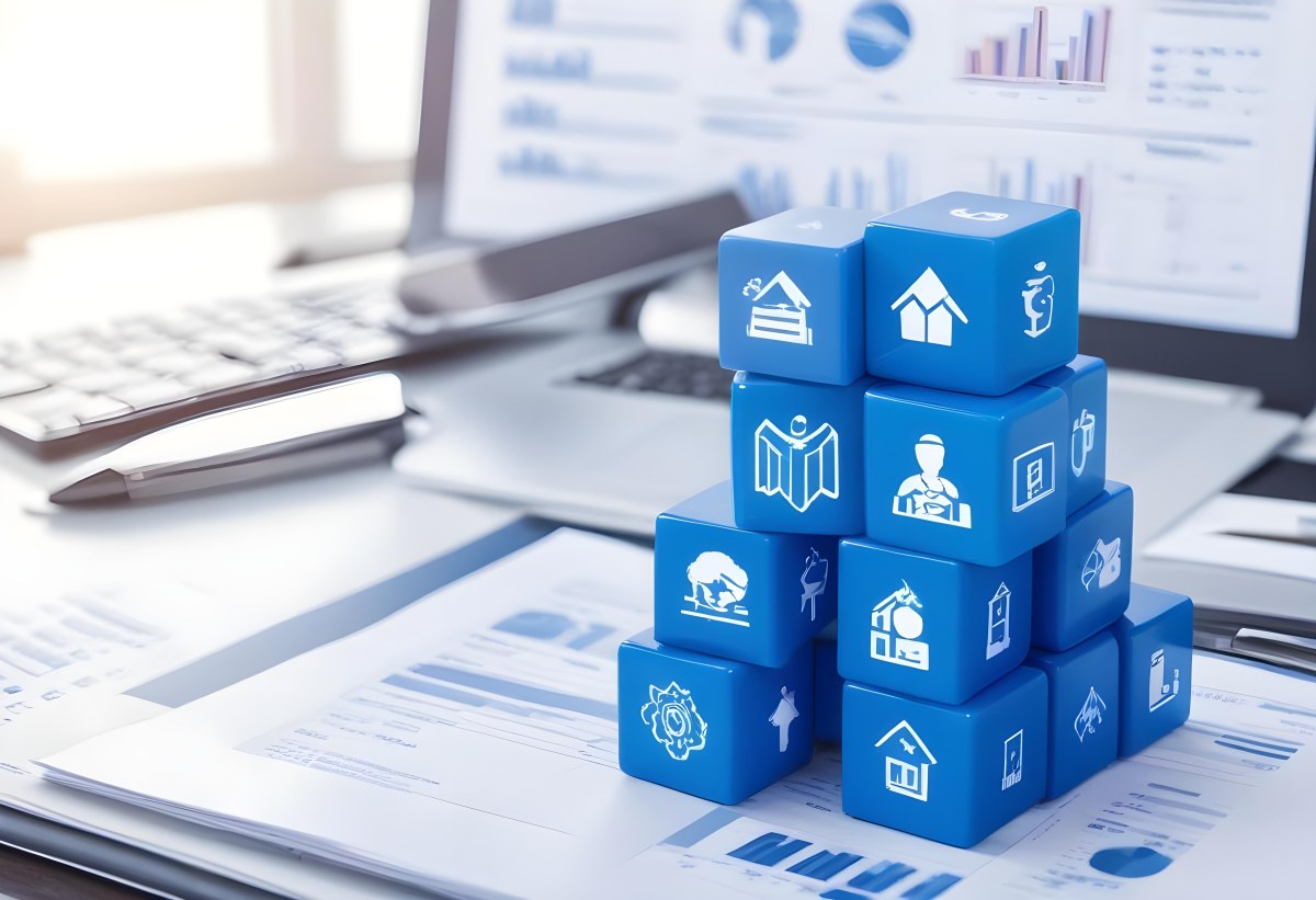 Stack Of Blue Cubes With Business Icons On Top Of A Financial Report With A Laptop In The Background 8 26bb