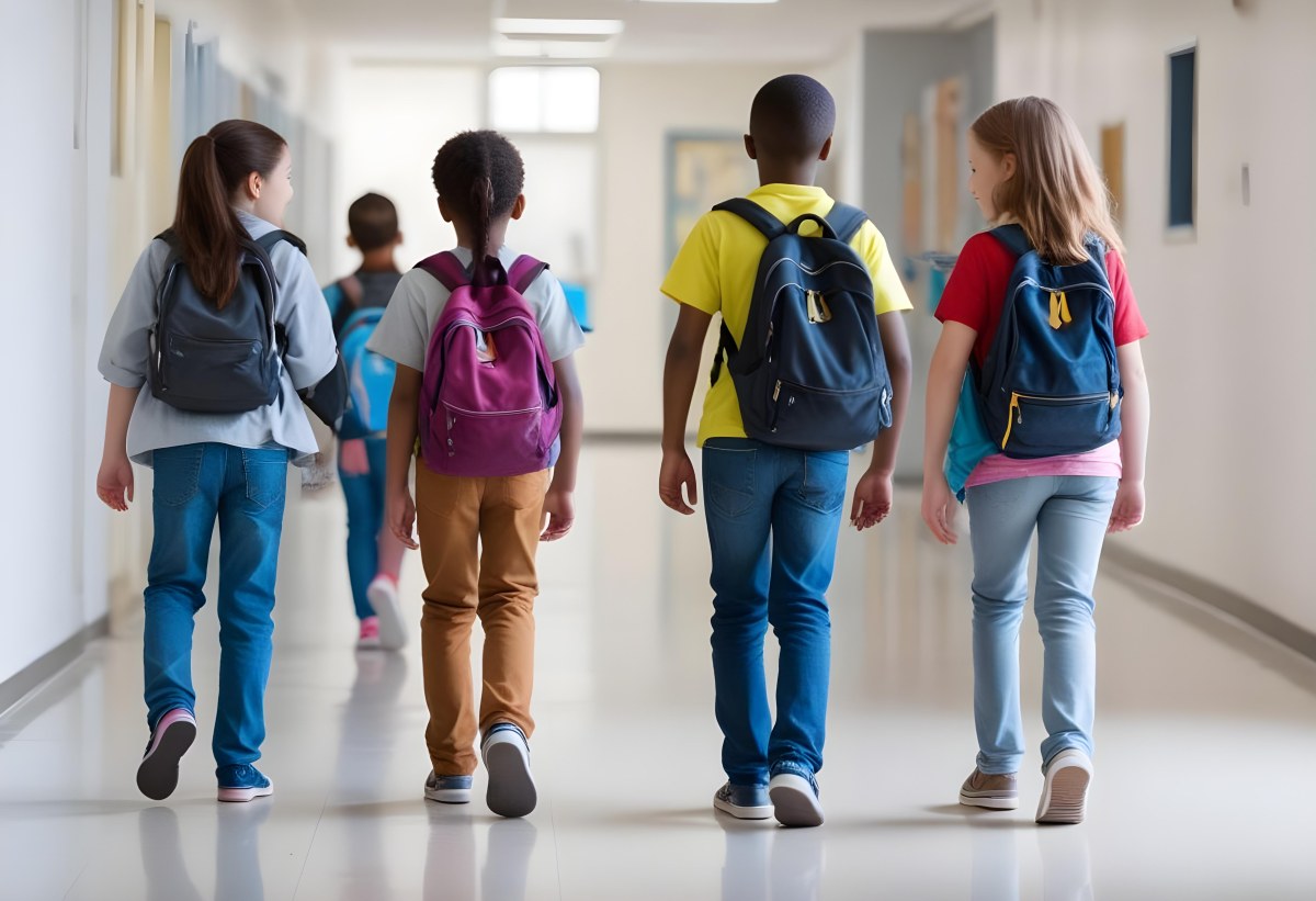 A Group Of Elementary School Students Walking Down A School Hallway Carrying Backpacks The Students Appear To Be A Mix Of Races With Both Boys And Girls And Are Wearing Casual Clothing Like Jeans And T Shirts 4 C73c