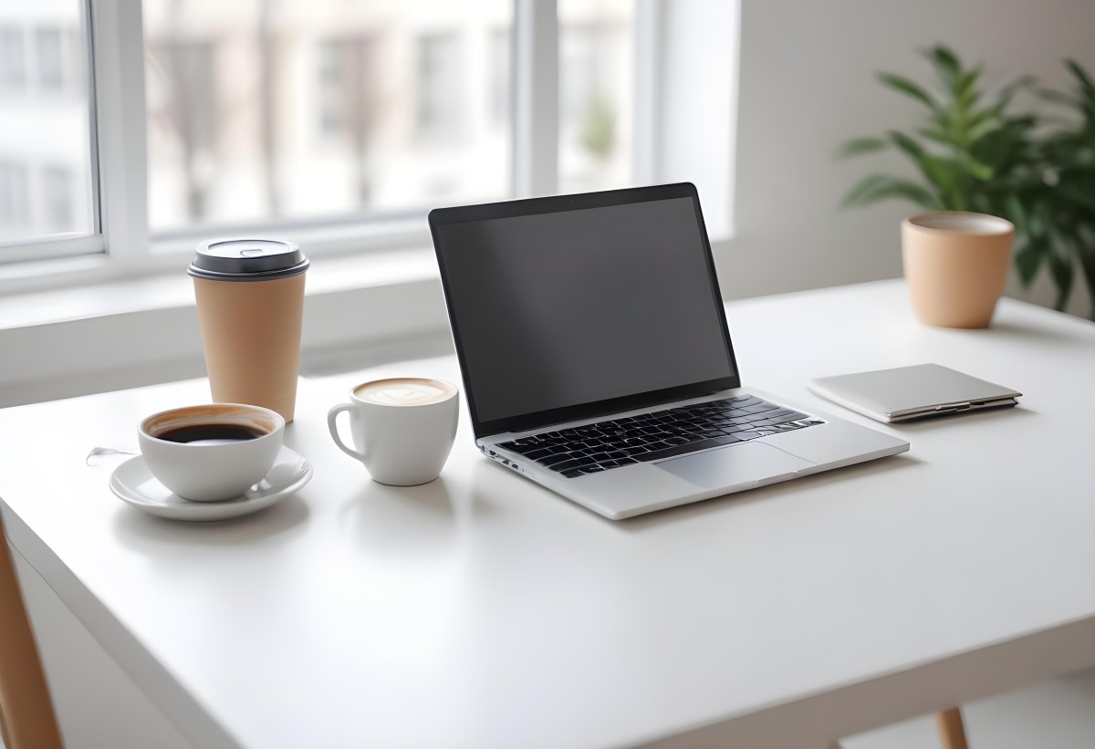 A Laptop And A Cup Of Coffee On A White Table In A Bright Environment With A Blurred Background 27 7d60