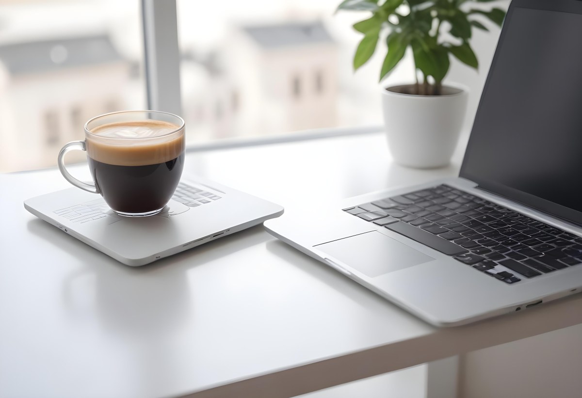 A Laptop And A Cup Of Coffee On A White Table In A Bright Environment With A Blurred Background 29 1953
