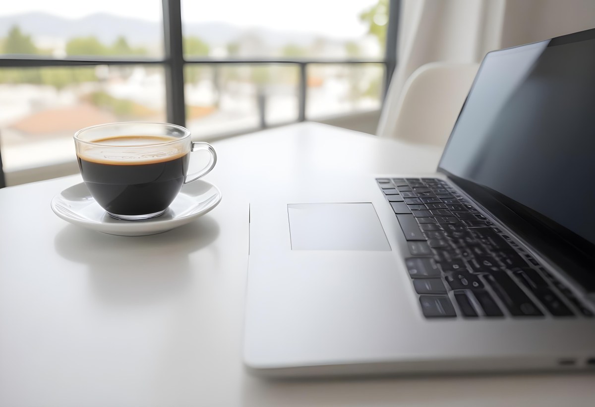 A Laptop And A Cup Of Coffee On A White Table In A Bright Environment With A Blurred Background 30 7a9e