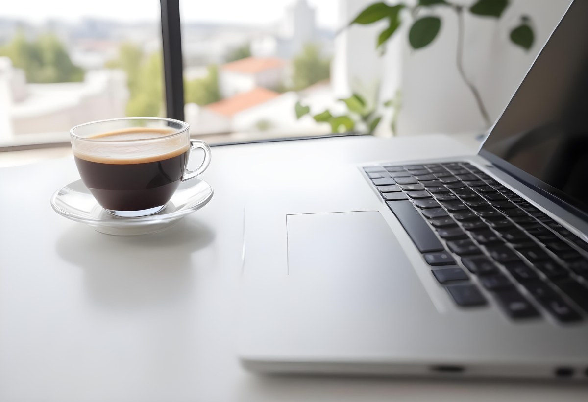 A Laptop And A Cup Of Coffee On A White Table In A Bright Environment With A Blurred Background 5 4f6e