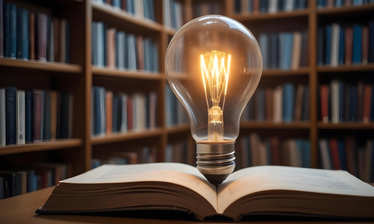 A Light Bulb On Top Of An Open Book Library In The Background With Many Books On The Shelves Warm Light Knowledge Concept 29 25a2