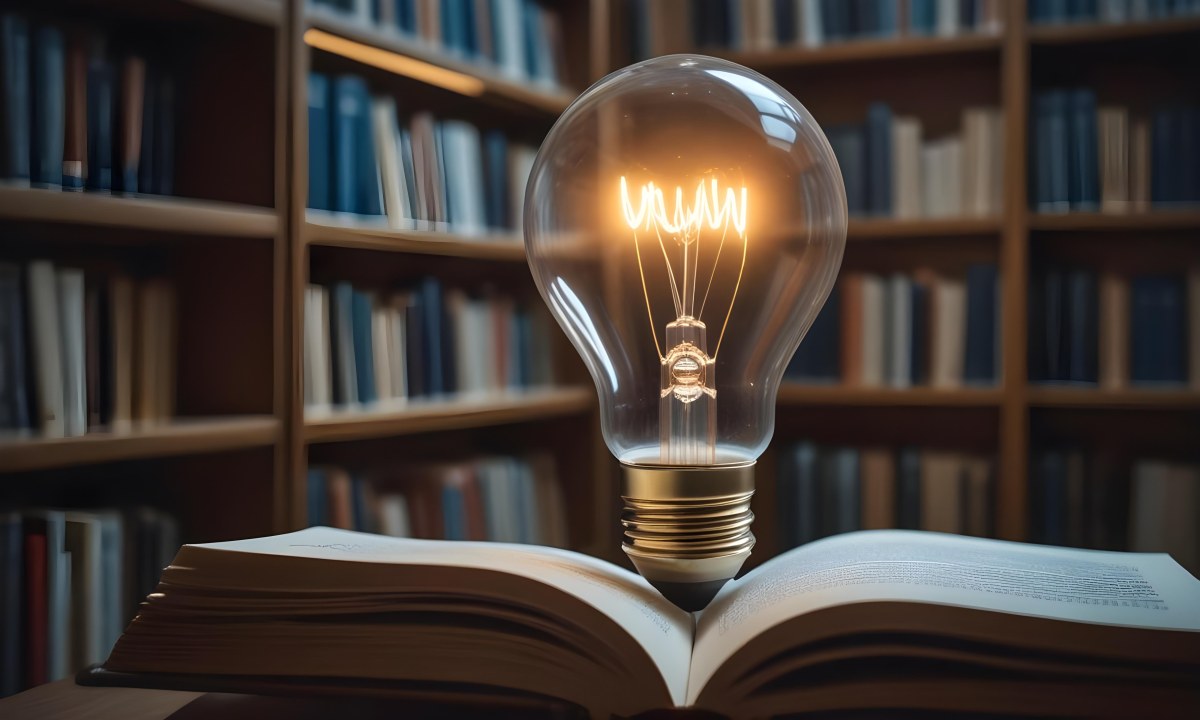 A Light Bulb On Top Of An Open Book Library In The Background With Many Books On The Shelves Warm Light Knowledge Concept 32 29d0