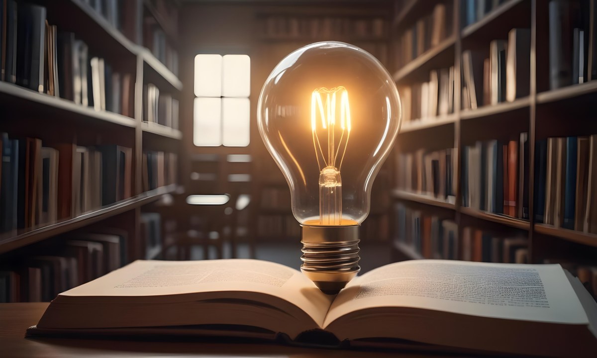 A Light Bulb On Top Of An Open Book Library In The Background With Many Books On The Shelves Warm Light Knowledge Concept 4 7a4e