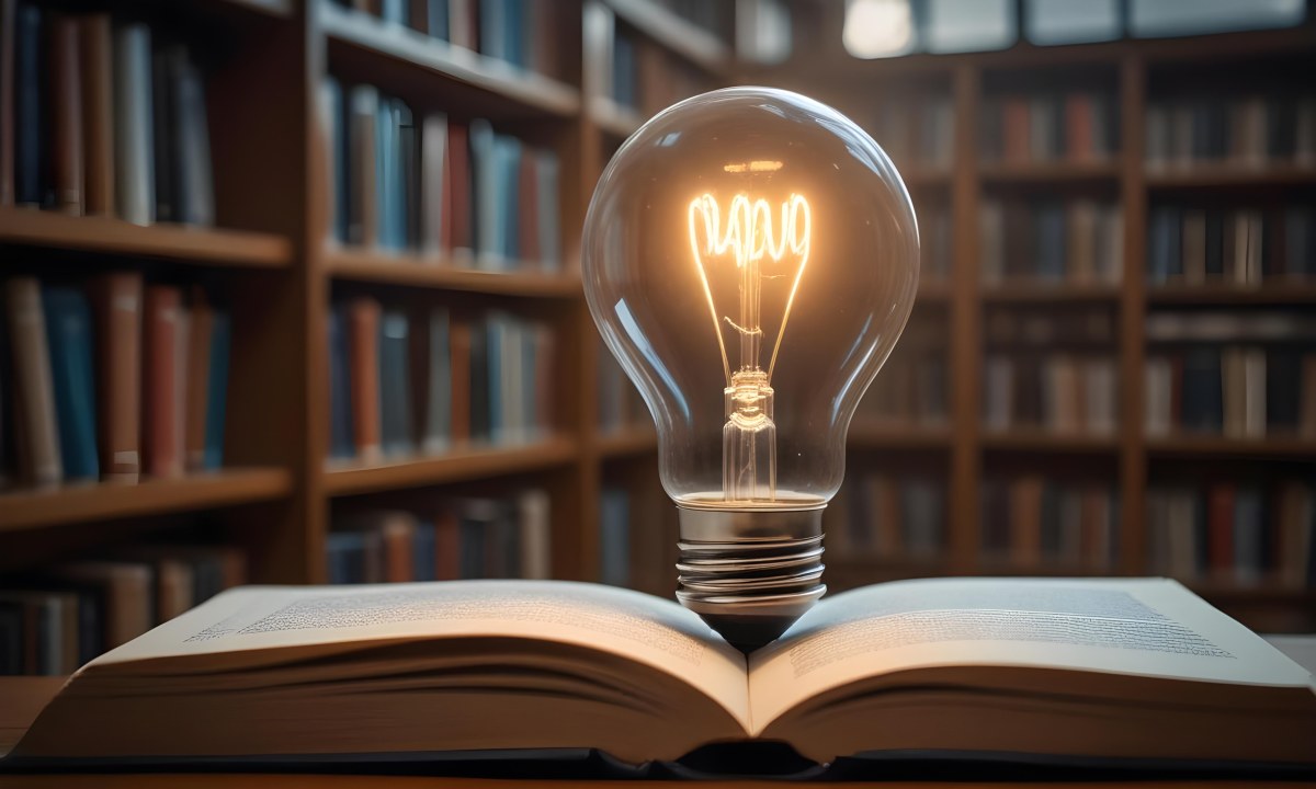 A Light Bulb On Top Of An Open Book Library In The Background With Many Books On The Shelves Warm Light Knowledge Concept 6 A10c