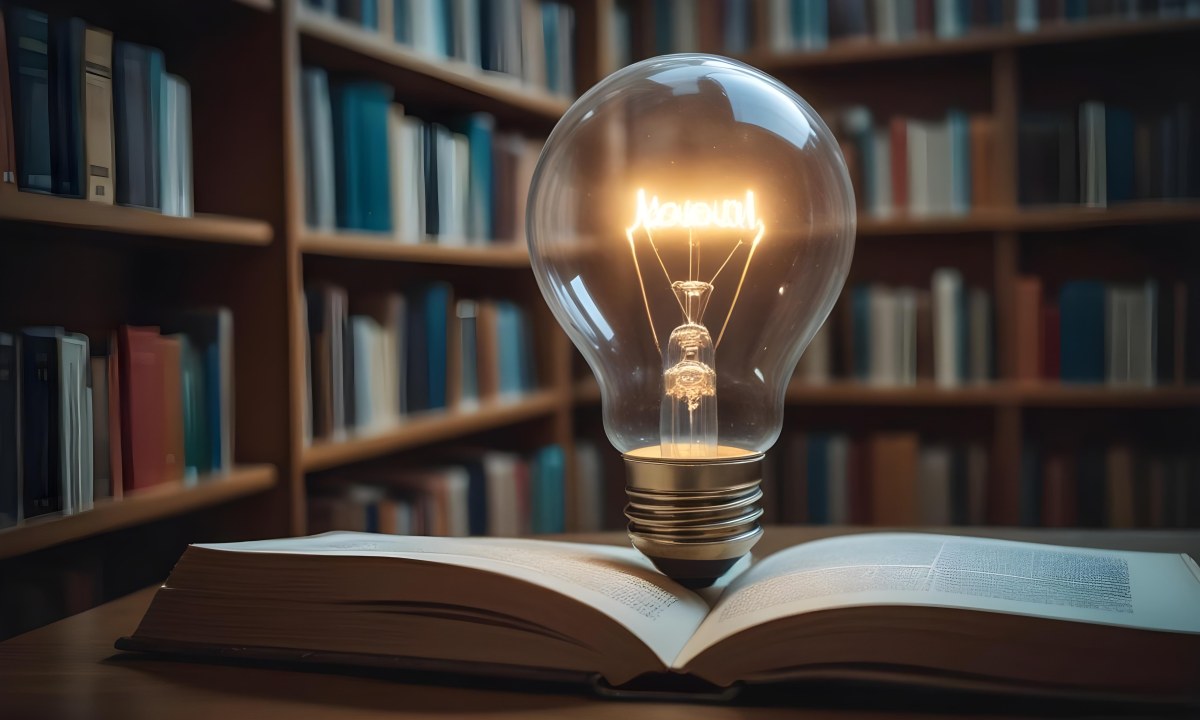 A Light Bulb On Top Of An Open Book Library In The Background With Many Books On The Shelves Warm Light Knowledge Concept 9 D163