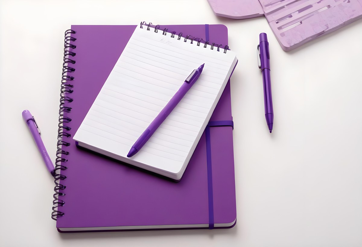A Purple Notebook With A Spiral Binding Several Purple Pencils And A Purple Pen On A White Surface 4 C153