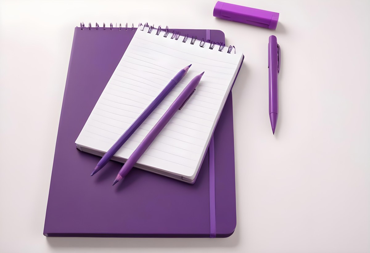 A Purple Notebook With A Spiral Binding Several Purple Pencils And A Purple Pen On A White Surface 6 Bf70
