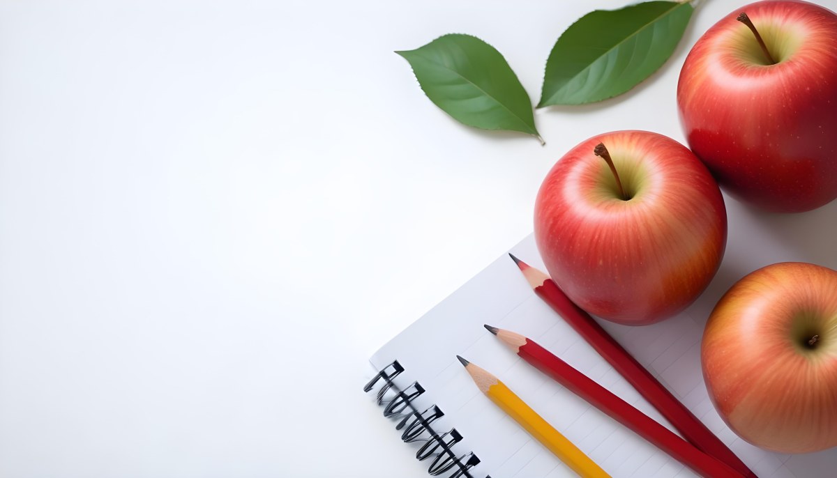 A Red Apple Pencils And A Notebook On A White Background With Green Leaves 7 E396