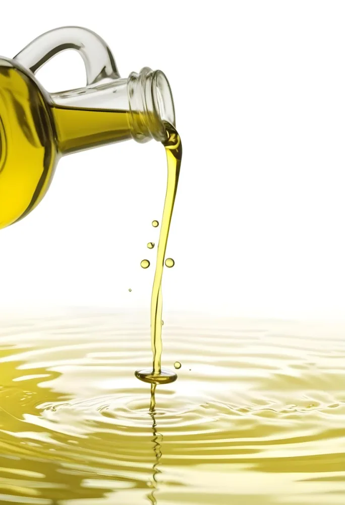 A Bottle Pouring Yellow Liquid Creating A Splash And Ripple Effect In The Water 12 773f