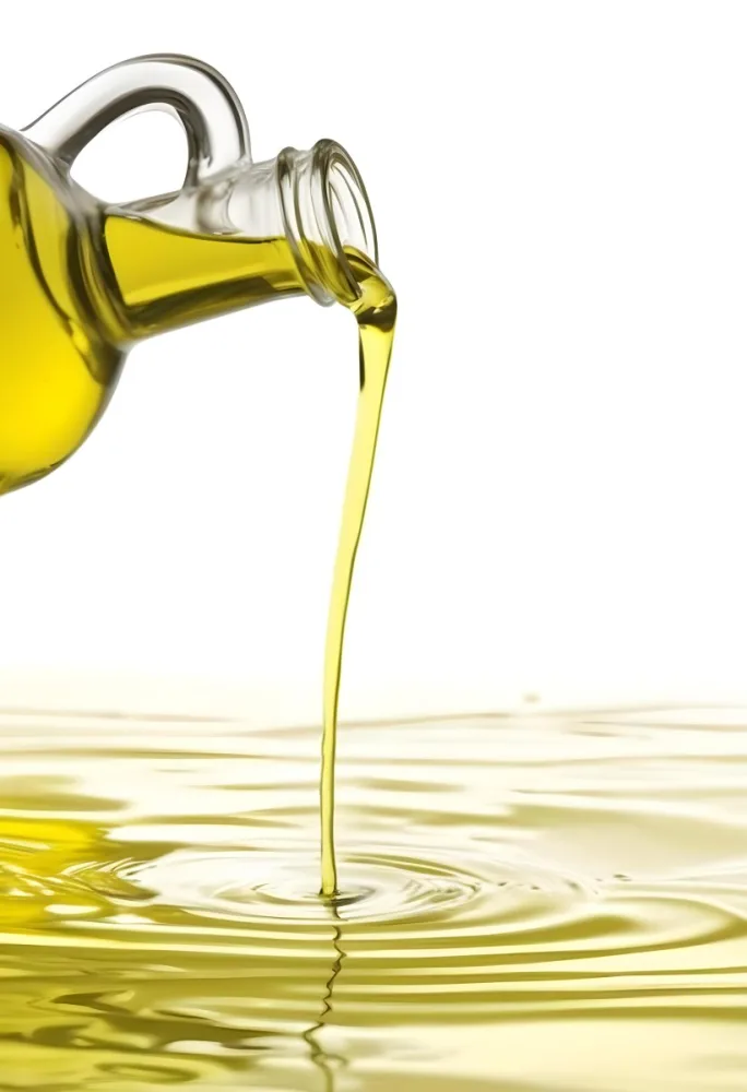A Bottle Pouring Yellow Liquid Creating A Splash And Ripple Effect In The Water 13 A5bb