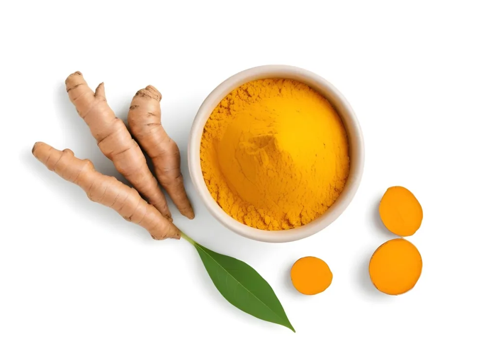 A Bowl Of Bright Yellow Turmeric Powder Surrounded By Fresh Turmeric Roots And Leaves 4 0ef6