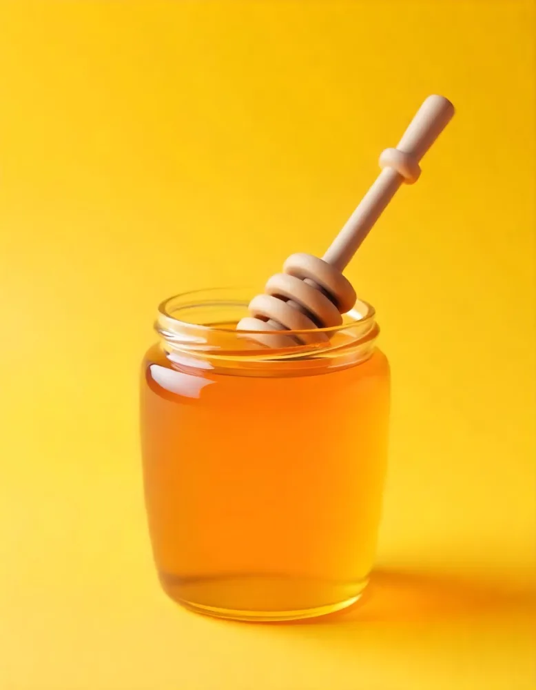 A Jar Full Of Honey With A Honey Dipper On A Yellow Background 3 Ffb7