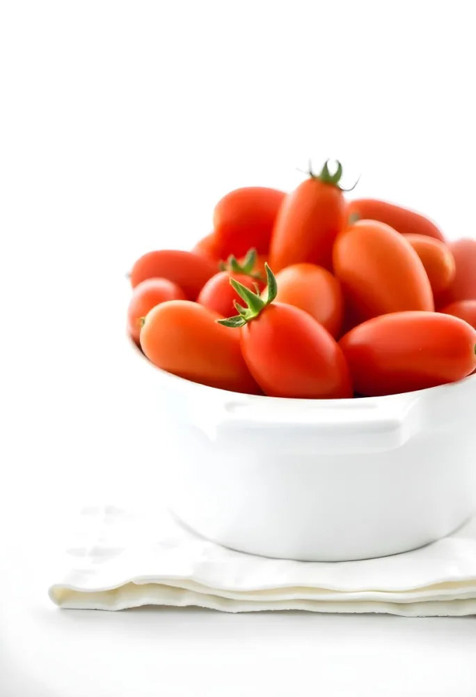 Cherry Tomatoes In A Red Bowl The Tomatoes Are Red And Ripe The Background Is Red And Out Of Focus 23 Bf44