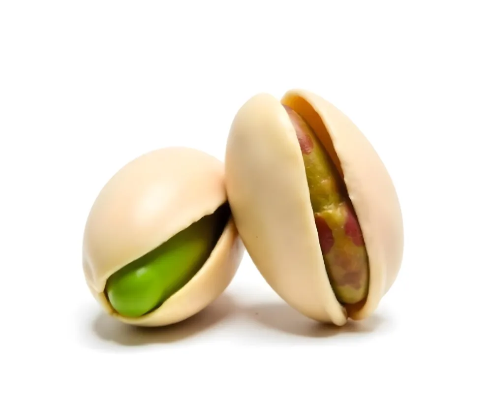 Two Pistachios One Closed And One Open Revealing The Green Nut Inside On A Green Background 43 Bf5e