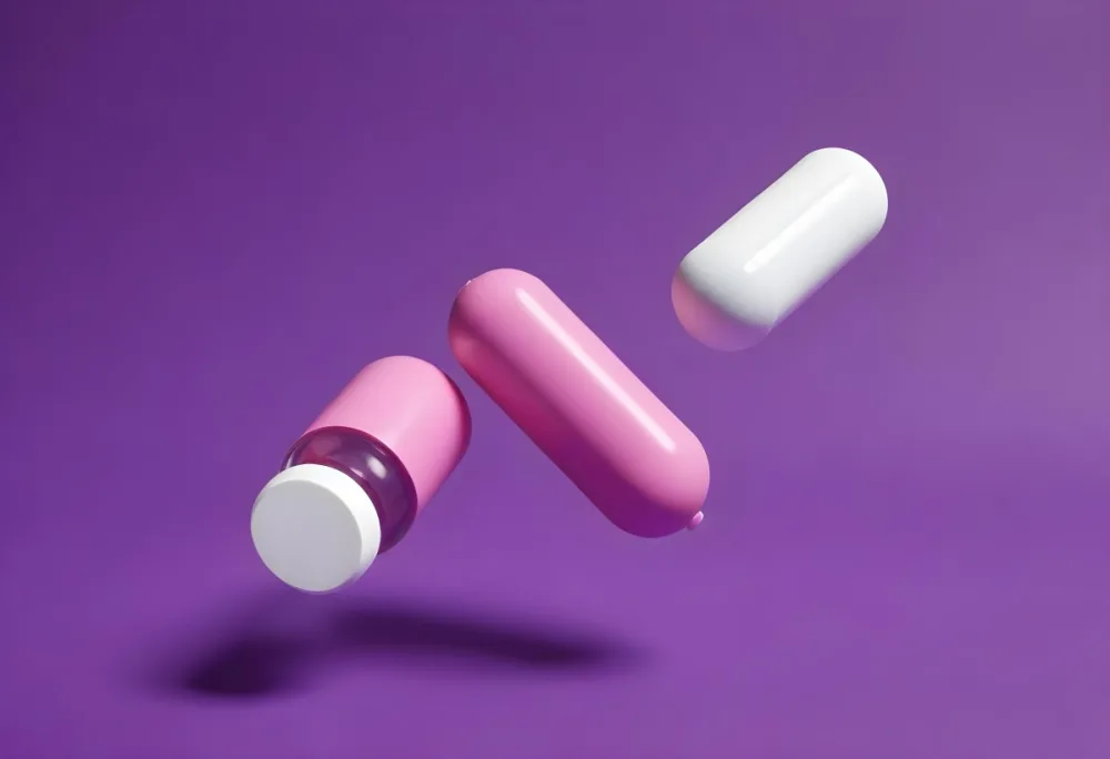 A Pink Pill And A Purple And White Capsule Floating In A Purple Background 5 6692