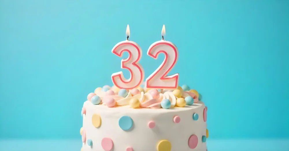 A Birthday Cake With Pastel Colors And A Number 32 Candle On Top In Front Of A Blue Background 1 Ae4d