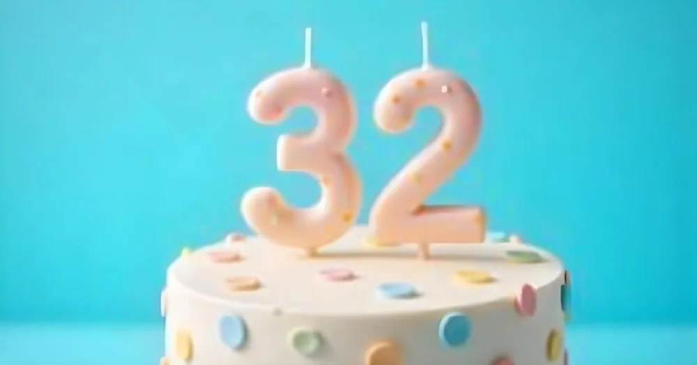 A Birthday Cake With Pastel Colors And A Number 32 Candle On Top In Front Of A Blue Background 15 482d