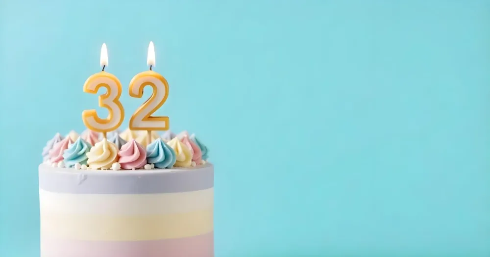 A Birthday Cake With Pastel Colors And A Number 32 Candle On Top In Front Of A Blue Background 19 27a9