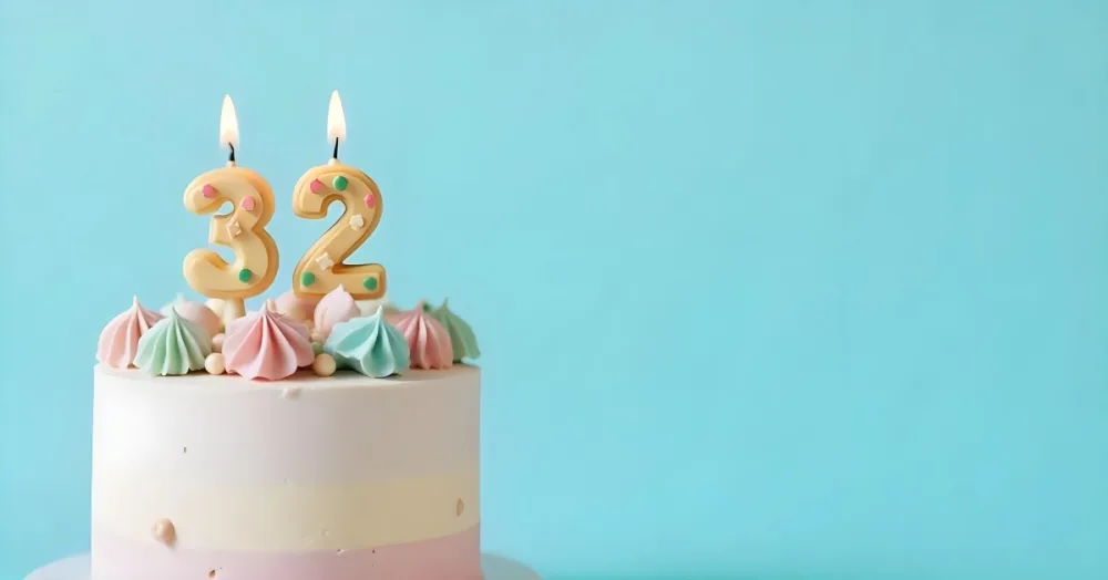 A Birthday Cake With Pastel Colors And A Number 32 Candle On Top In Front Of A Blue Background 22 B660