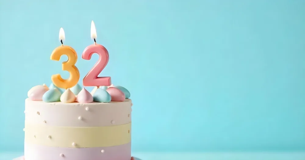 A Birthday Cake With Pastel Colors And A Number 32 Candle On Top In Front Of A Blue Background 25 38be