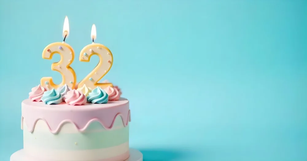 A Birthday Cake With Pastel Colors And A Number 32 Candle On Top In Front Of A Blue Background 26 Fd93