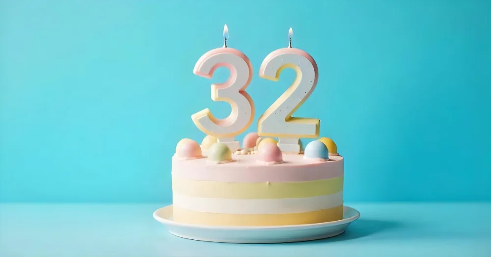 A Birthday Cake With Pastel Colors And A Number 32 Candle On Top In Front Of A Blue Background 28 6922