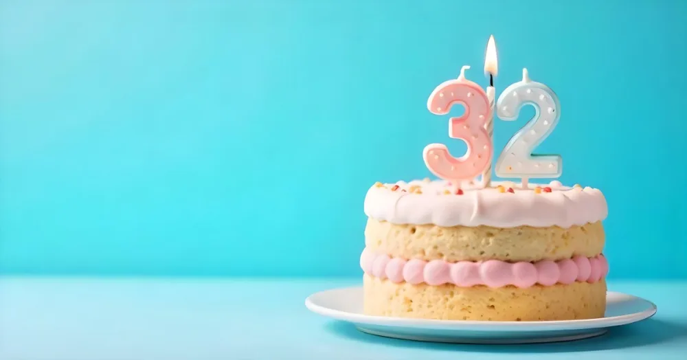 A Birthday Cake With Pastel Colors And A Number 32 Candle On Top In Front Of A Blue Background 3 F35c