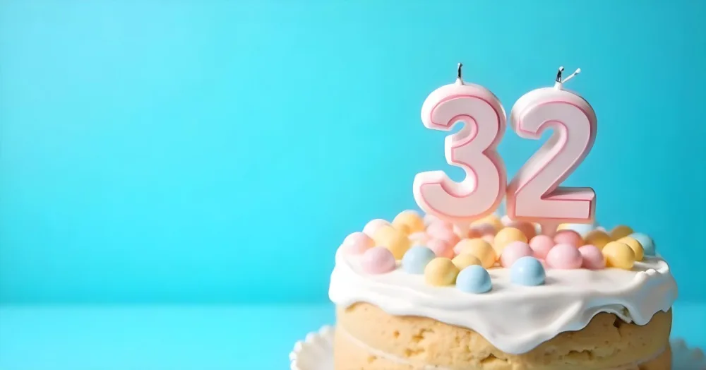 A Birthday Cake With Pastel Colors And A Number 32 Candle On Top In Front Of A Blue Background 4 4024