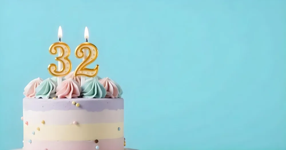 A Birthday Cake With Pastel Colors And A Number 32 Candle On Top In Front Of A Blue Background 8 17f6