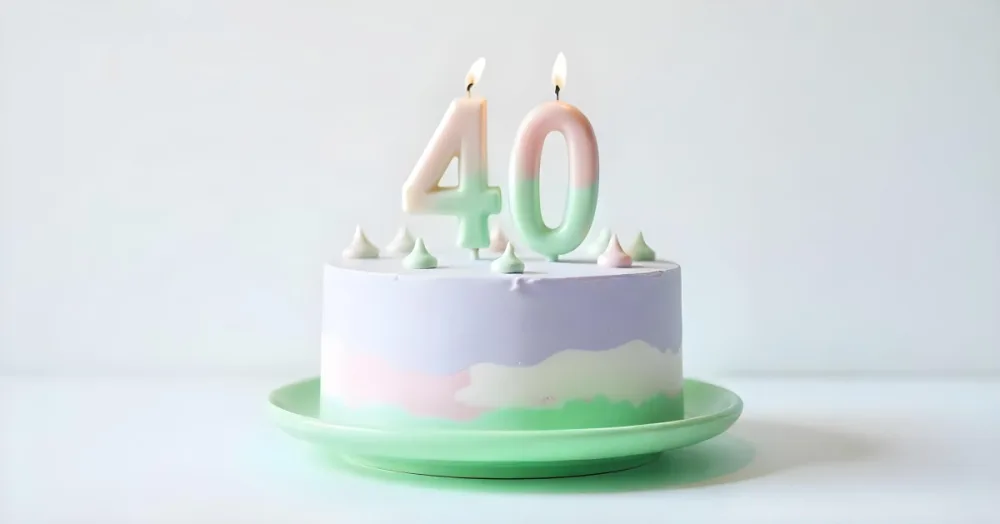 A Birthday Cake With Pastel Colors And Number 40 Candles On A Green Plate Light Purple And Green Frosting Plain White Background 5 546e