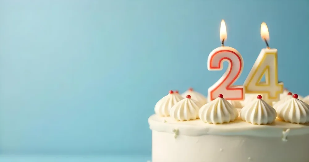 A Birthday Cake With White Frosting And A Candle In The Shape Of The Number 24 Light Blue Background 9 2590