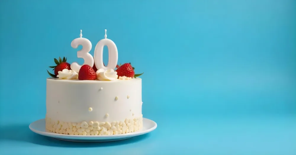 A Cake With Strawberries And Raspberries On Top With A Number 30 Candle On A Blue Background 15 5dd0